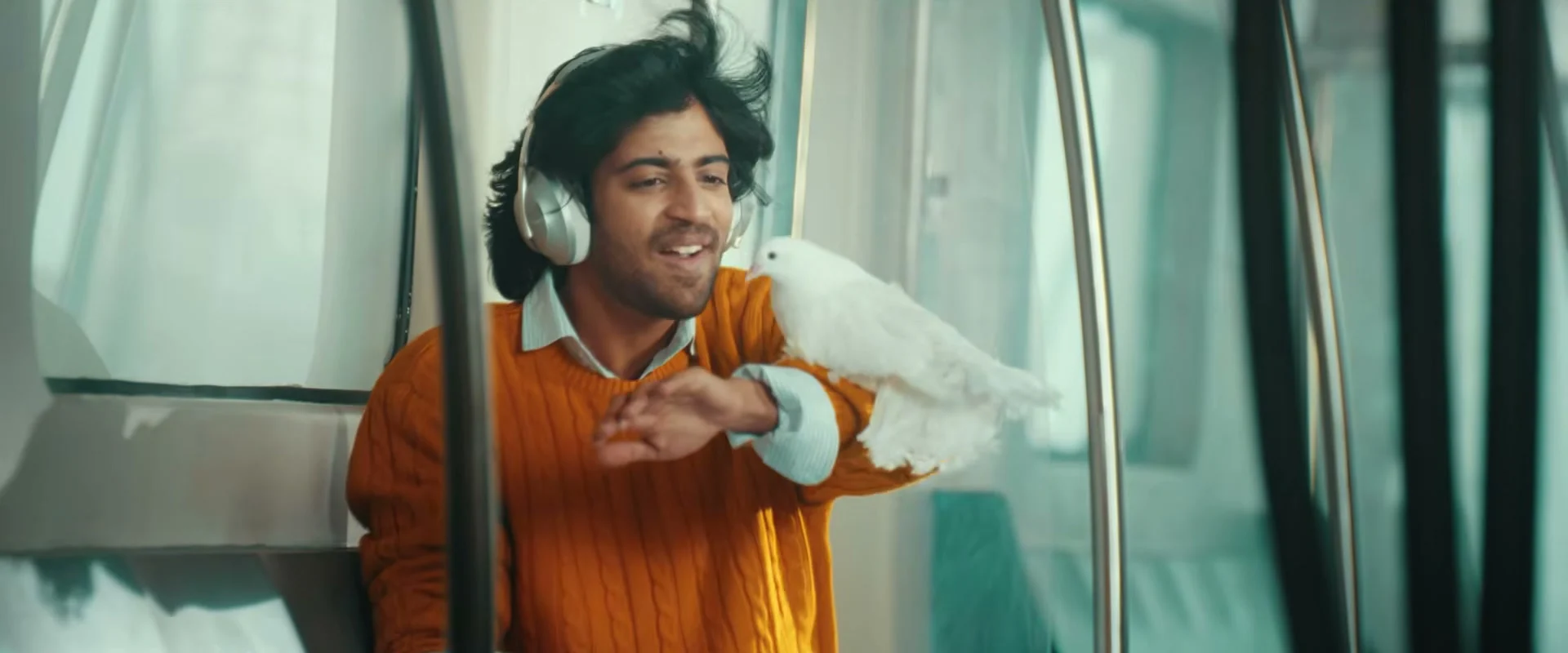 Vivasvaan smiling with a bird at a train window