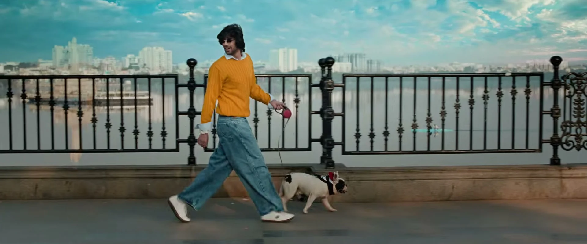 Vivasvaan walking a dog beside a city waterfront